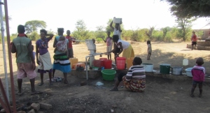 Mothers getting water to make bricks
